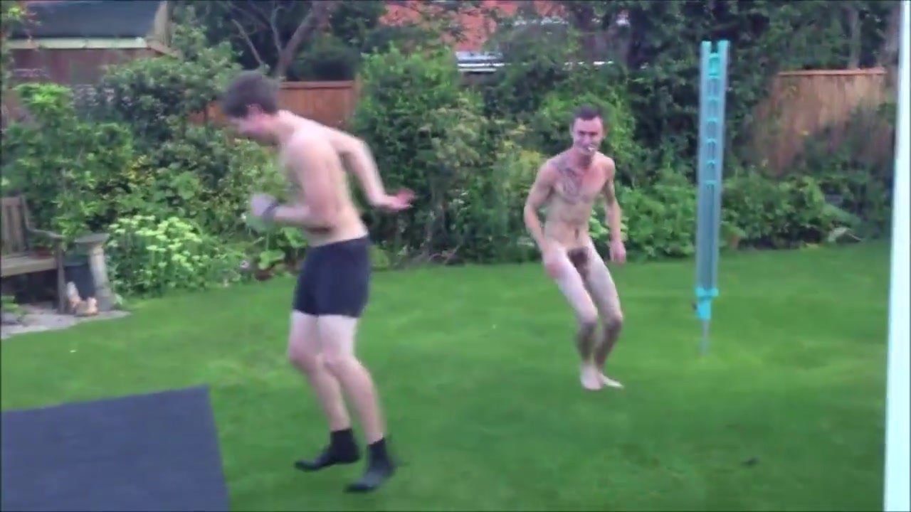 two nude friends funny fighting in the garden