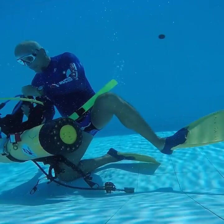 Daniel gearing underwater in speedos