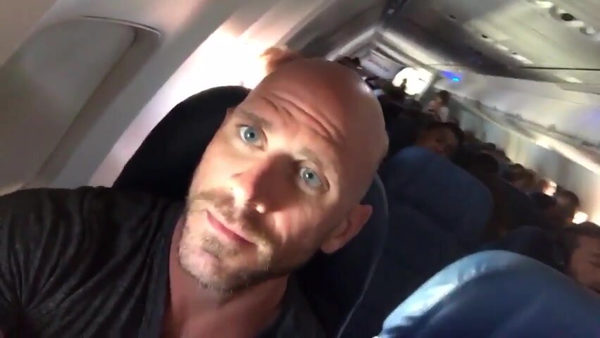 Blue Eyed Muscle Daddy flashes perfect penis on a plane