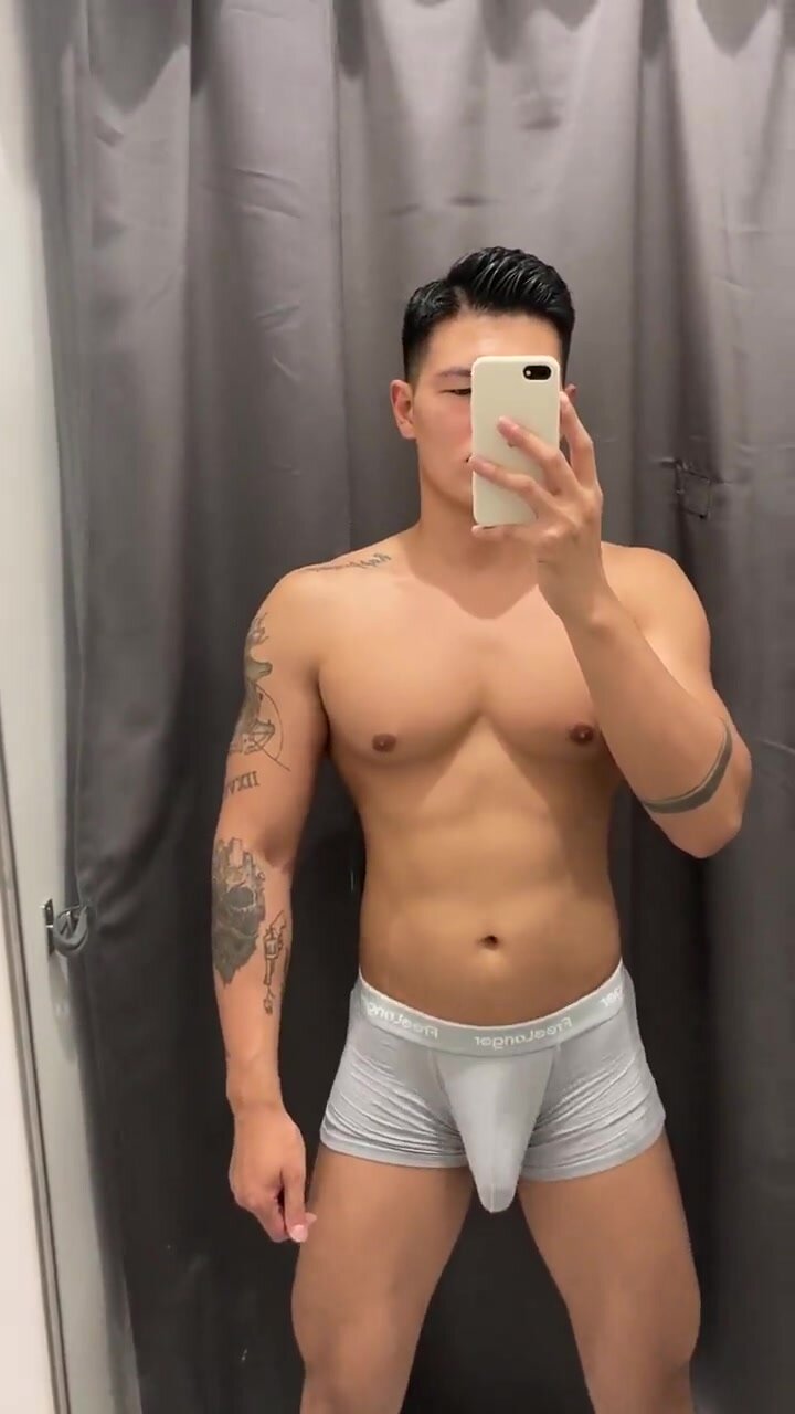 Horny dude flinging his bulge in a public changing room