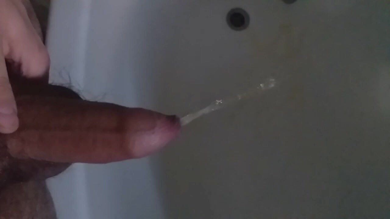 Hot uncut cock piss in the tub