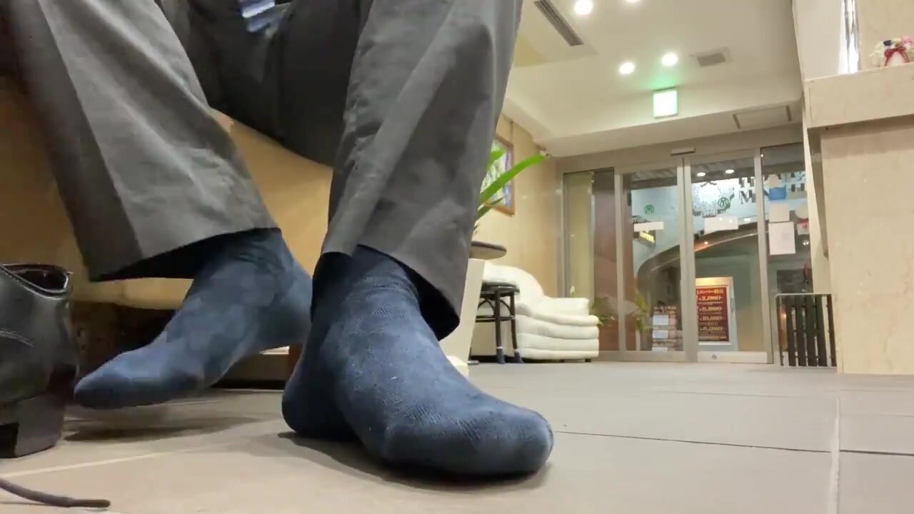 Japanese salaryman shows his smelly feet