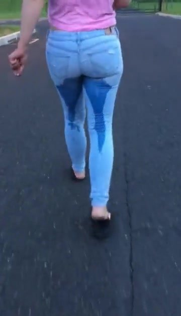 Woman wets jeans while walking
