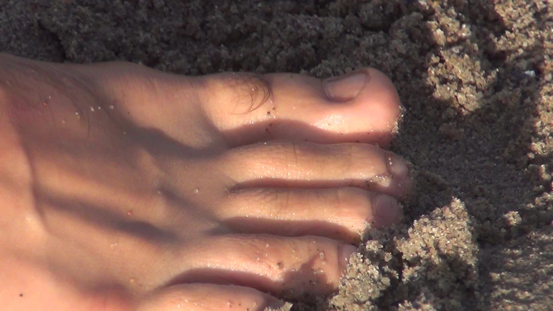 Guy shows cute feet at the beach