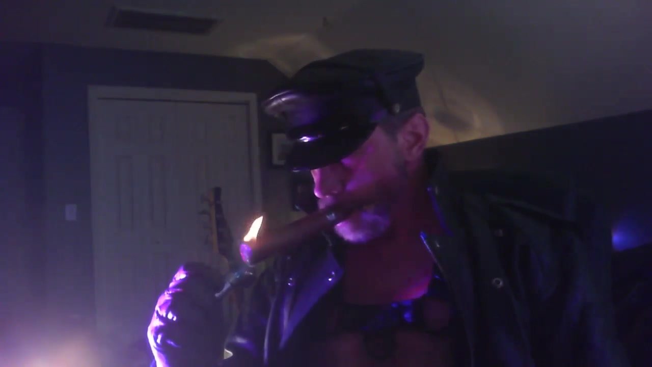Hot leather stud firing up a cigar
