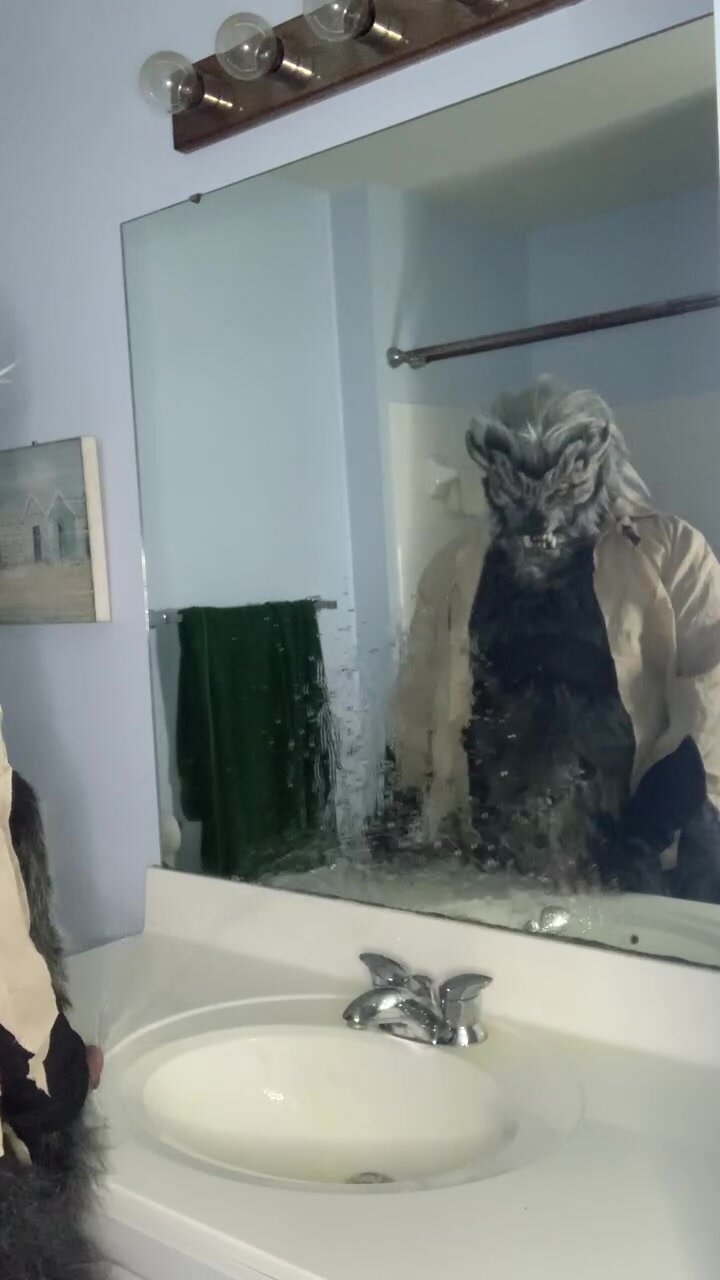 Wolfman pisses on mirror and sink