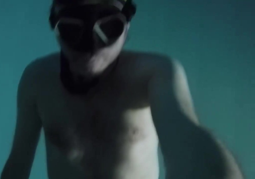 Freediving deep underwater in blue speedo - video 2