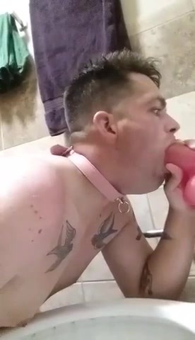 Sissy faggot whore sucks on a big  pink dildo