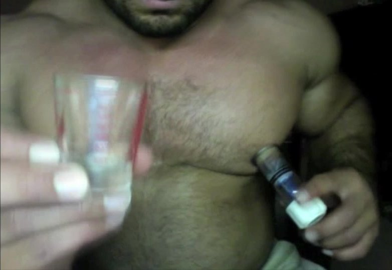 Bodybuilder lactates milk into shot glass and drinks it