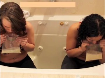 Two girls puke in a tub