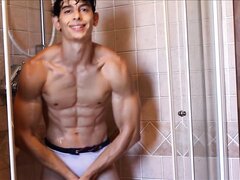 Beautiful muscular young man in the shower
