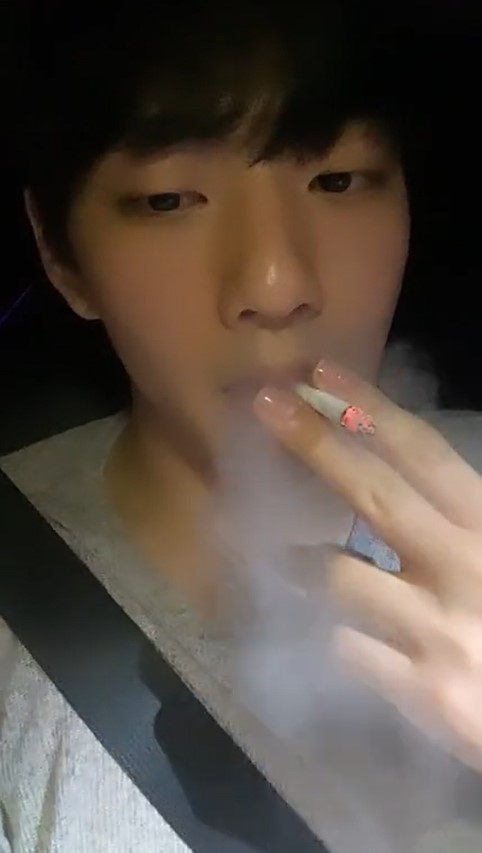 Cute Korean guy chaining a couple cigs in the car (3)