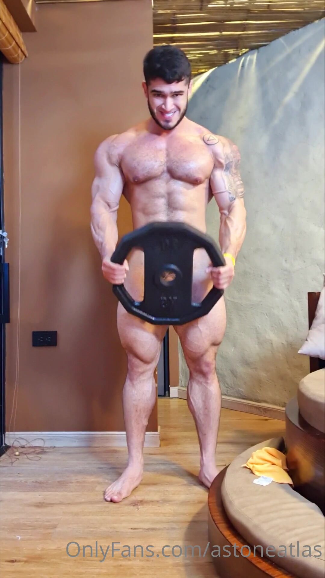 man lifting disk while naked