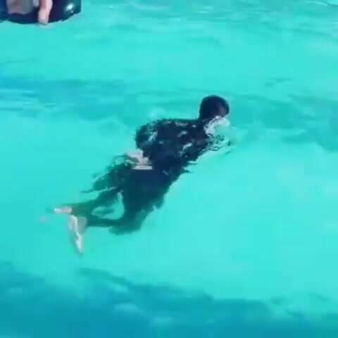 another guy swimming with hands and feet tied
