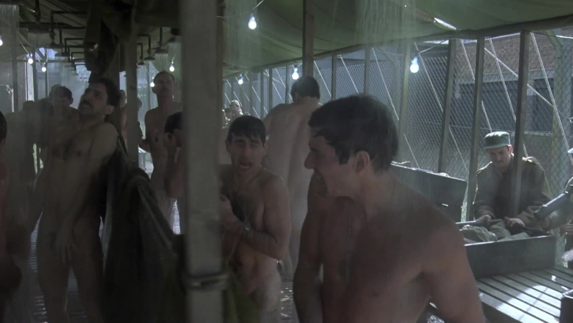 Many naked actors in military shower