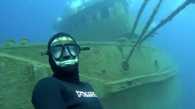 Exploring an underwater wreck in wetsuit