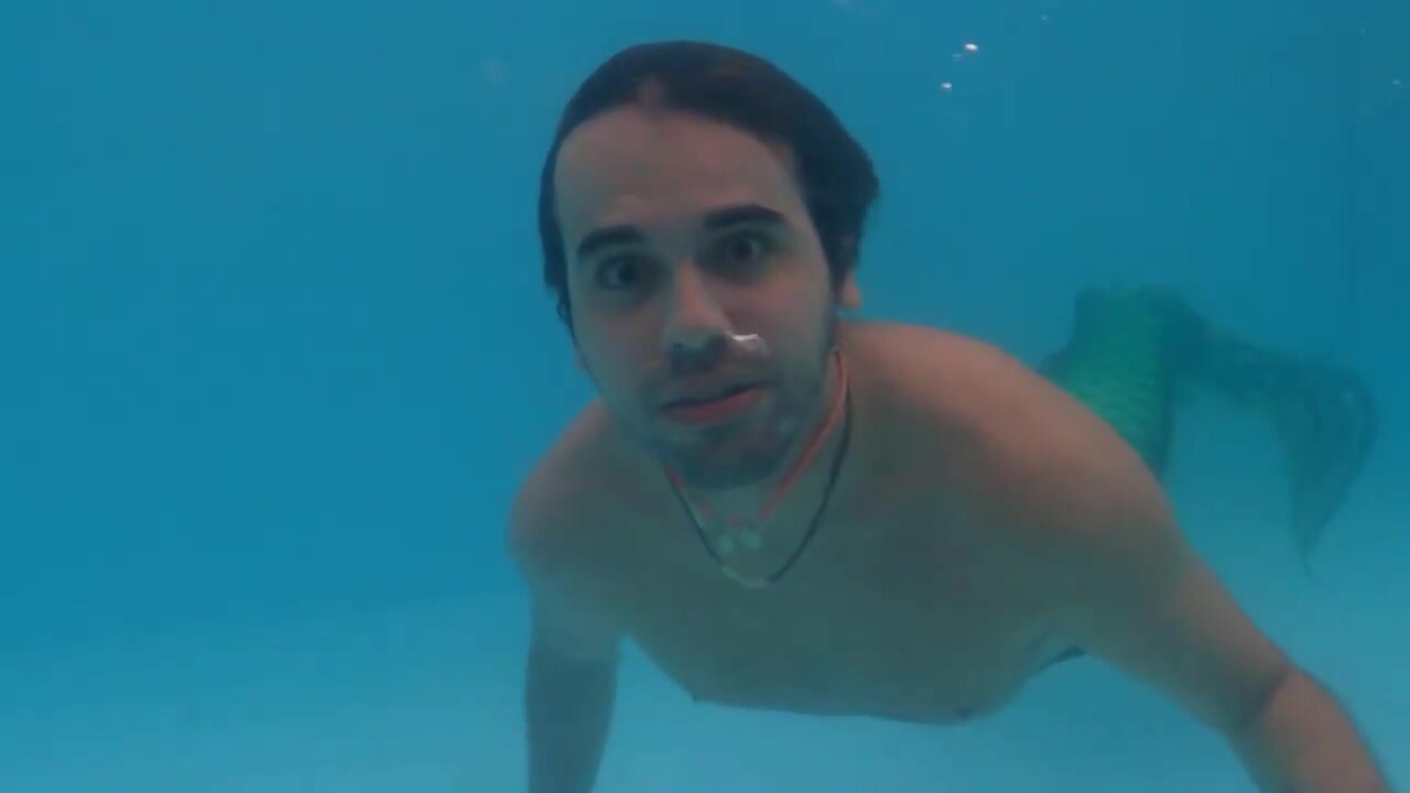 Underwater cute barefaced merman