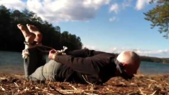old guy hogtied outdoors