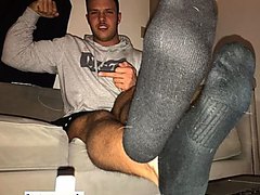 Young cashmaster showing his sweaty feet
