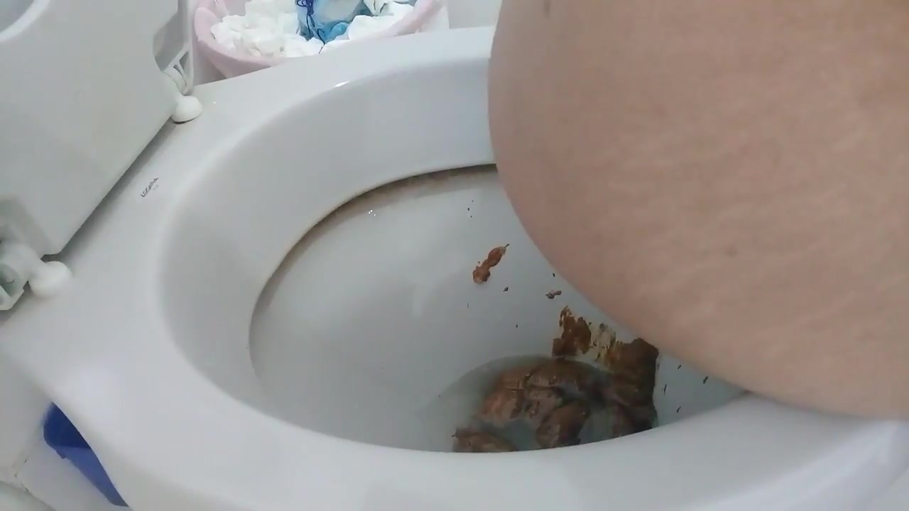 A boy shitting on the toilet