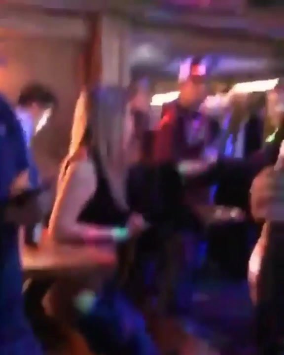 Very drunk girl pissing in a crowded bar