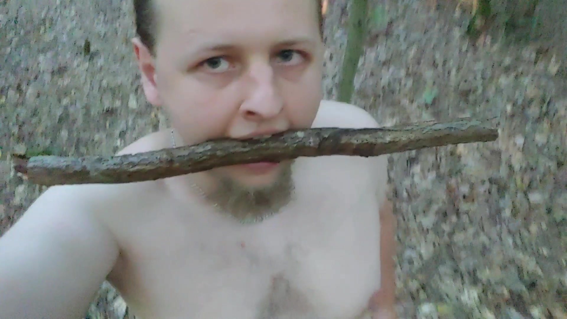 Naked whore locked in a chastity belt in the woods