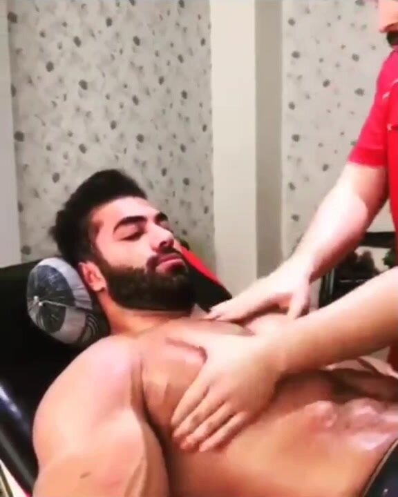 Muscle man getting his muscle tit massaged