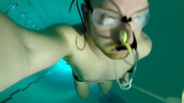 Deep underwater with fluid goggles and speedo