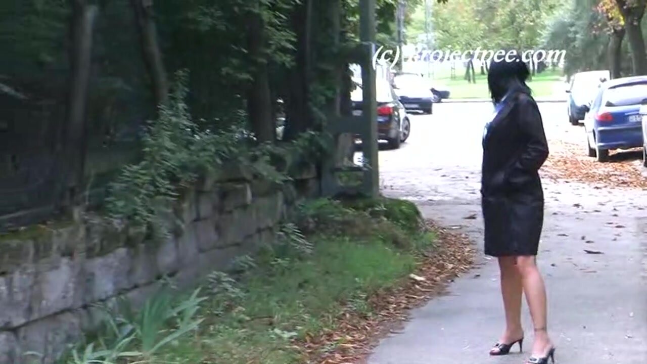 Woman pisses on concrete pavement