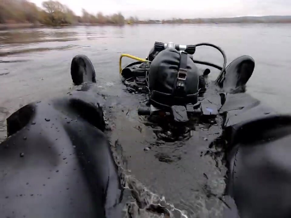 kinky drysuit dive above water with buddy