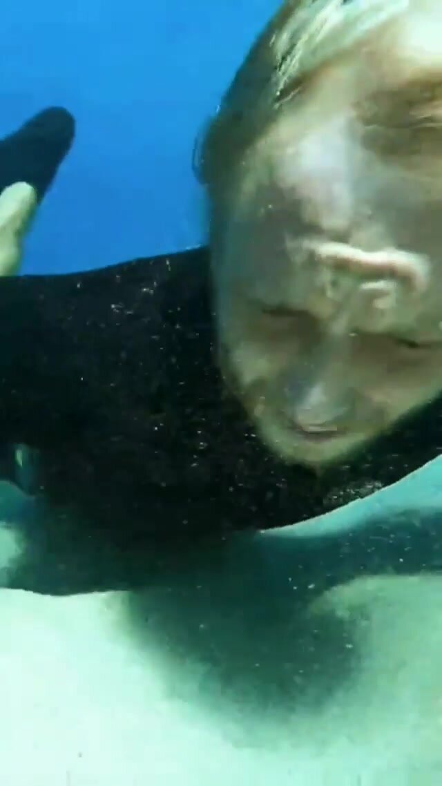 Underwater barefaced blondie eating sand