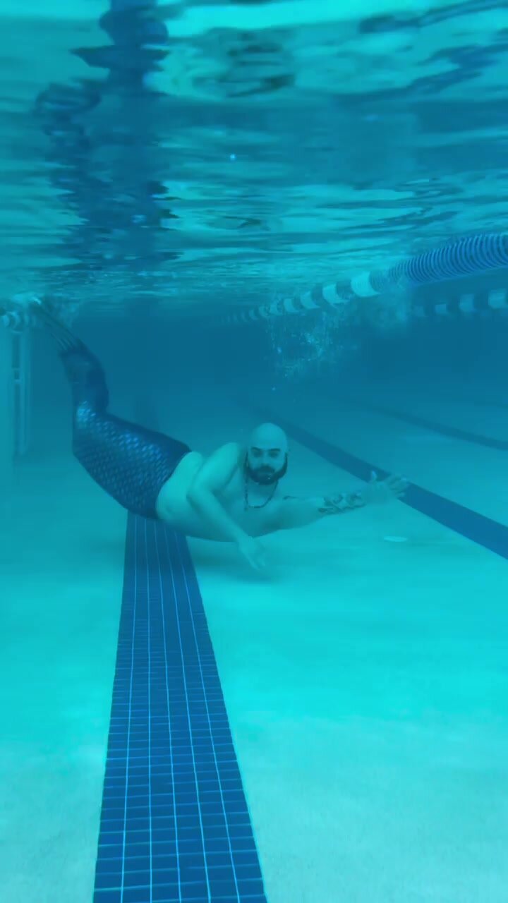 Underwater barefaced bald bearded merman