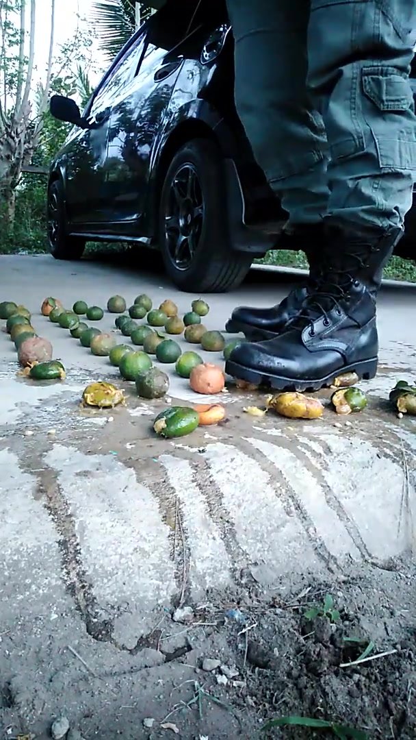 Soldier crushing fruits with his army boots