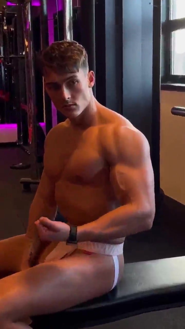 Muscled jock wearing jockstrap and working out