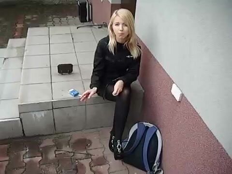 Blonde girl smoking and spitting outdoor