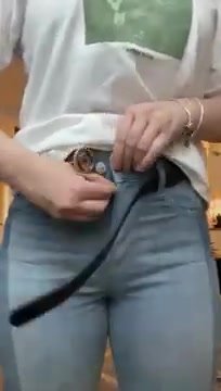 Buttoning and unbuttoning tight blue jeans - video 2