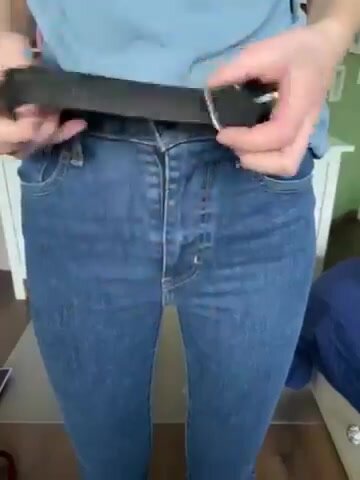 Buttoning and unbuttoning tight blue jeans - video 3