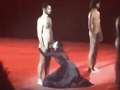 Naked actors show their dicks to a clothed woman