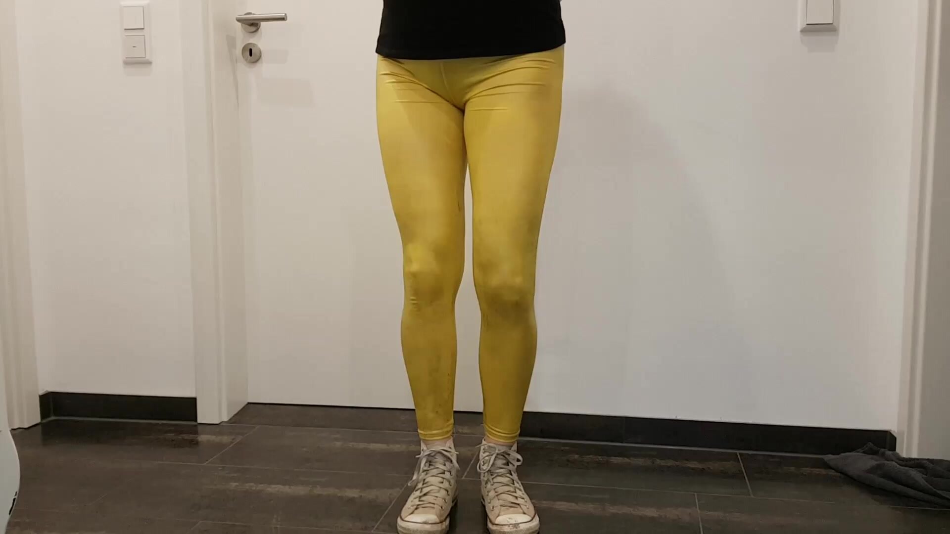 Girl wetting her yellow leggings