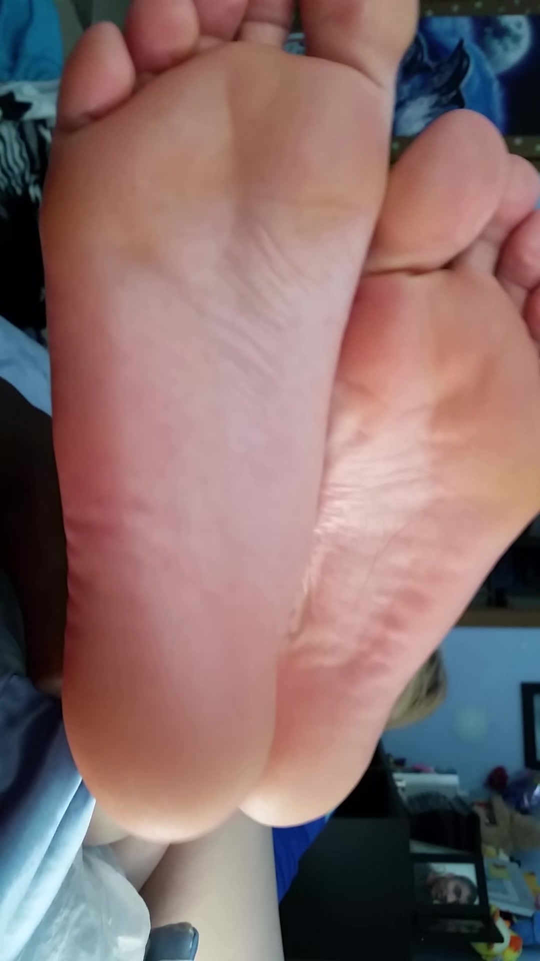 (STRAIGHT) Blonde girl's soles relaxing on bed