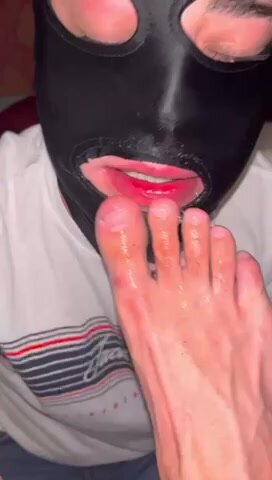 Slave cleans toe jam and sock lint from toes and feet
