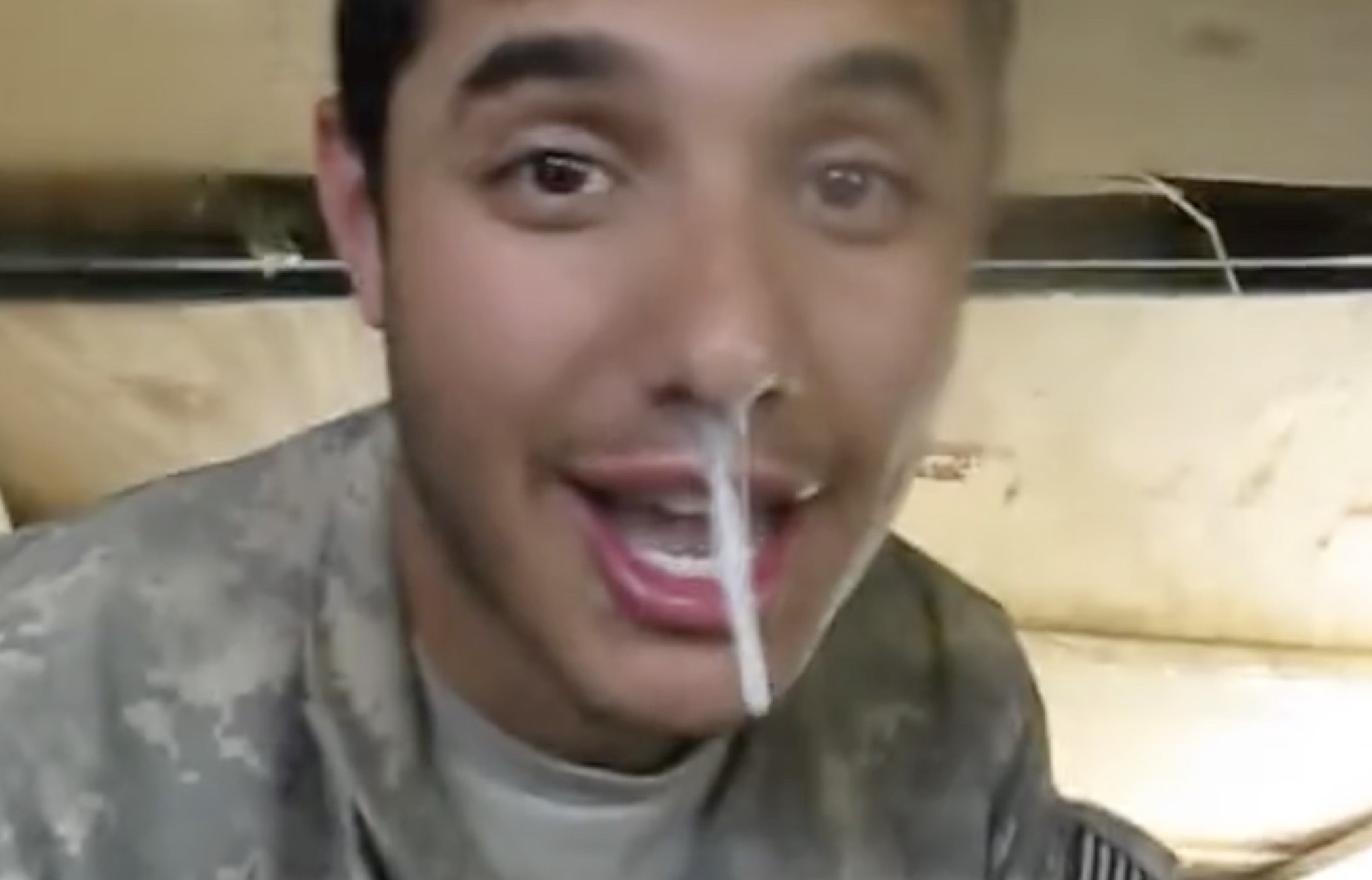 Soldier plays with his snot