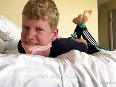 cute boy hogtied and tickled on bed