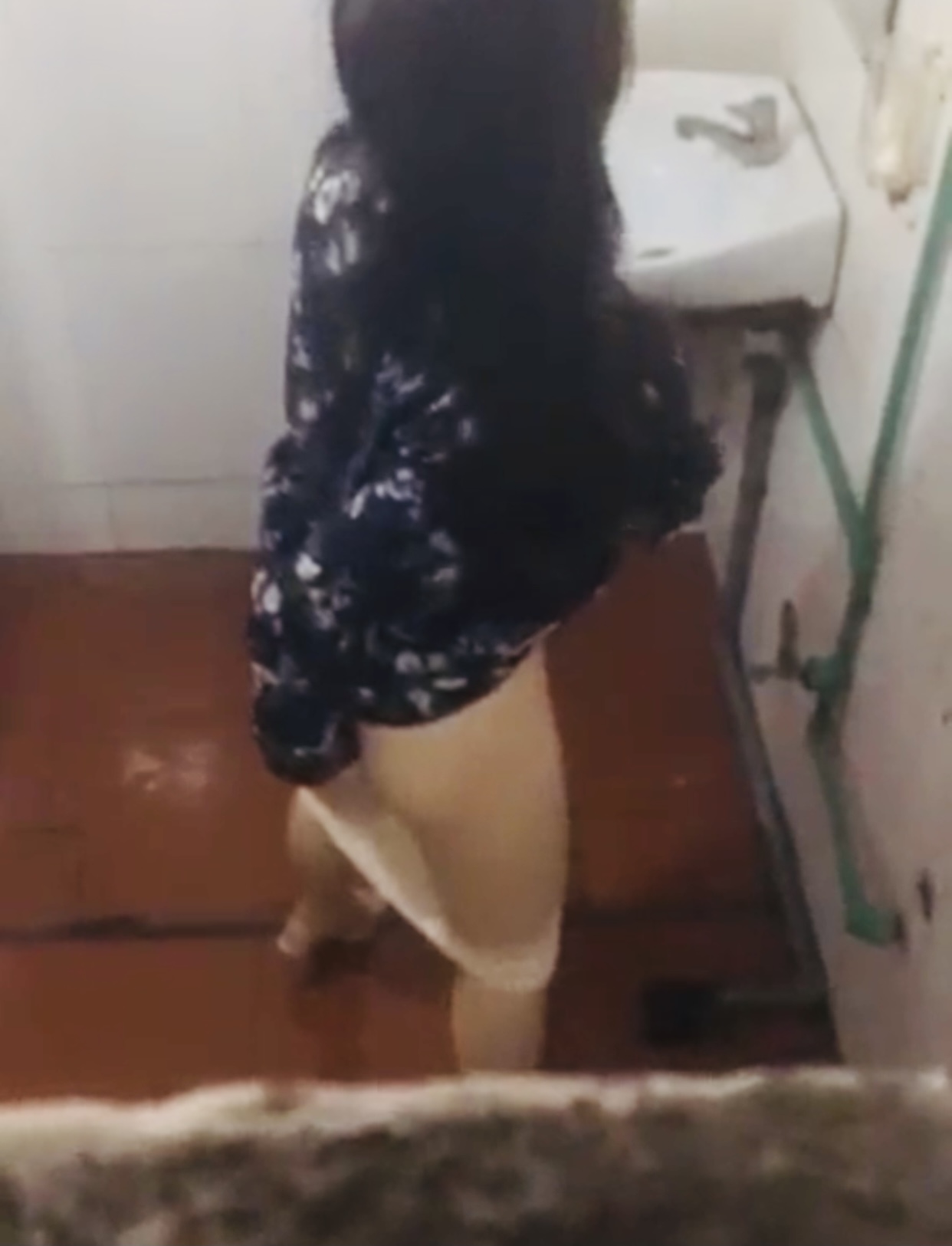 Girl pissing at cafe toilet