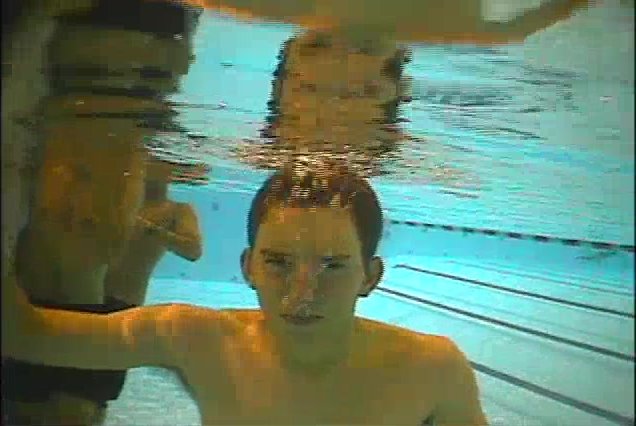 Underwater barefaced skinny guy exhaling air
