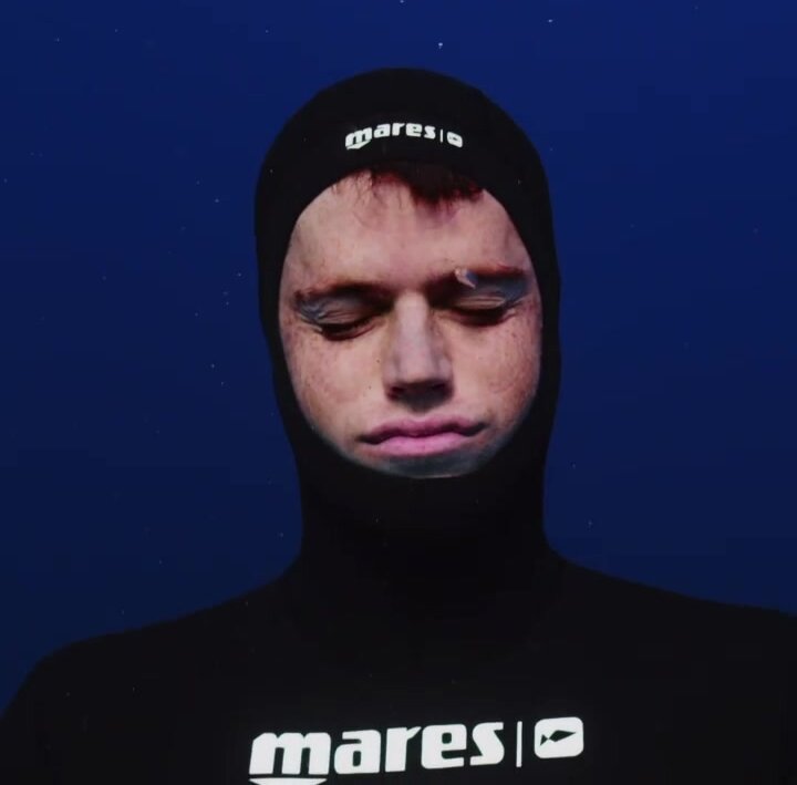 Underwater barefaced hunk in wetsuit