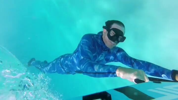 Underwater breathold in tight blue wetsuit