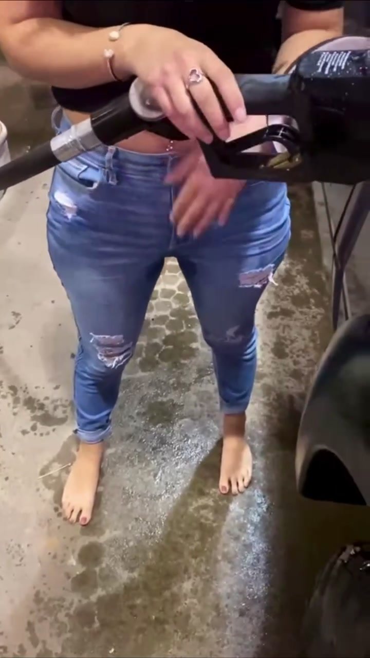 Girl wets jeans at gas station
