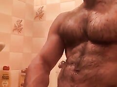 Hairy guy jerks off in the shower