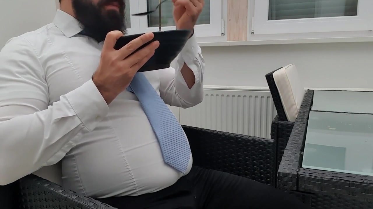Office boss in suit belly stuffing